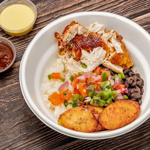 Picaso Chicken bowl with grilled chicken, rice, black beans, pico de gallo, and fried plantains.