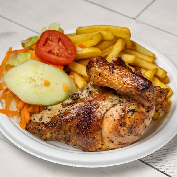 Picaso Chicken's grilled chicken with crispy fries and a fresh side salad on a white plate.